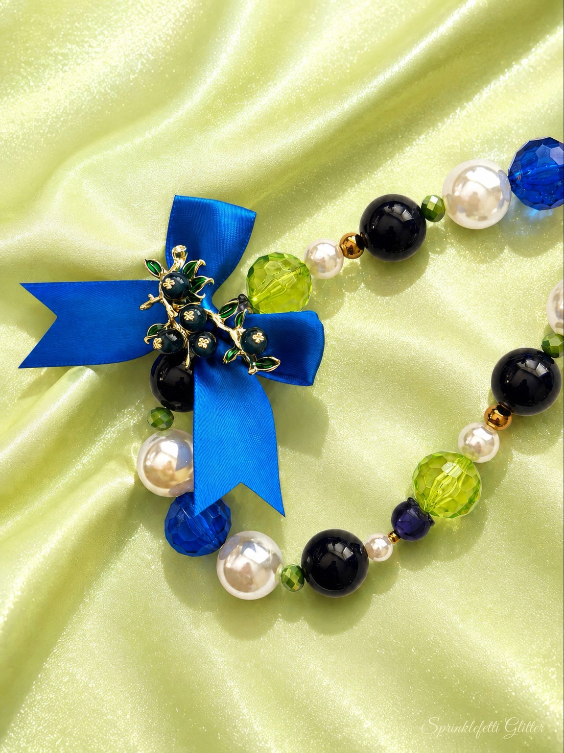 Blueberry Heirloom statement necklace with blue, lime, black and pearl beads, Austrian crystals and satin bow on pure white background