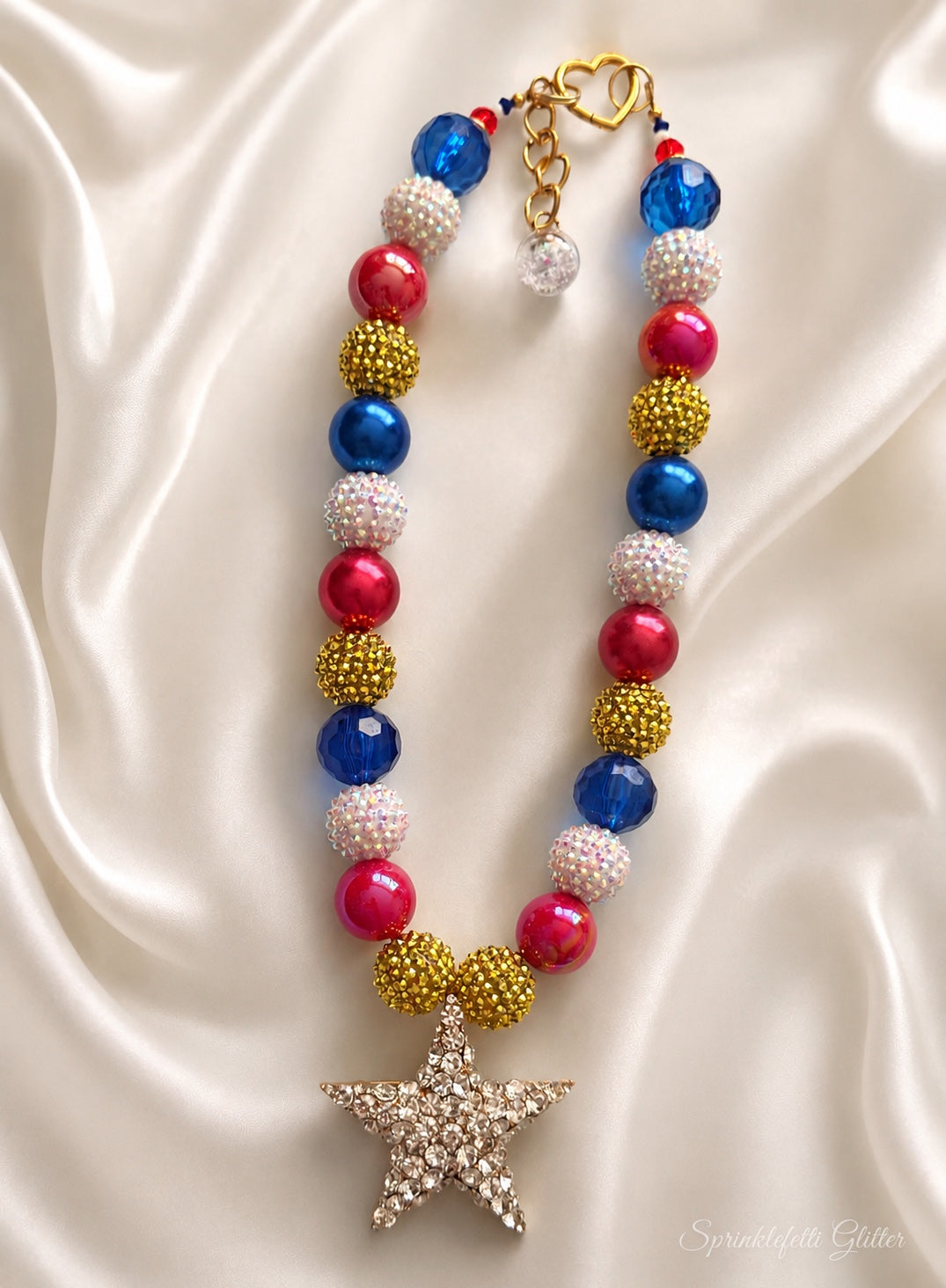 Star Spangled Heiress statement necklace with red, blue, white and gold beads and crystal-covered star pendant