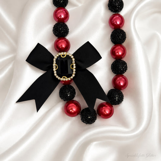 Crimson Heiress Necklace with crimson pearls, black sparkle beads, and jeweled black bow