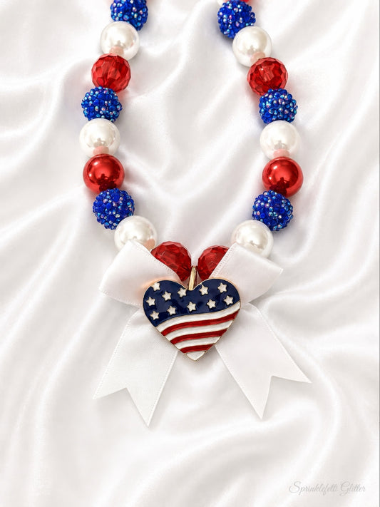 Grand Ole Glamour patriotic pearl necklace with Austrian crystals, satin bow and stars-and-stripes heart