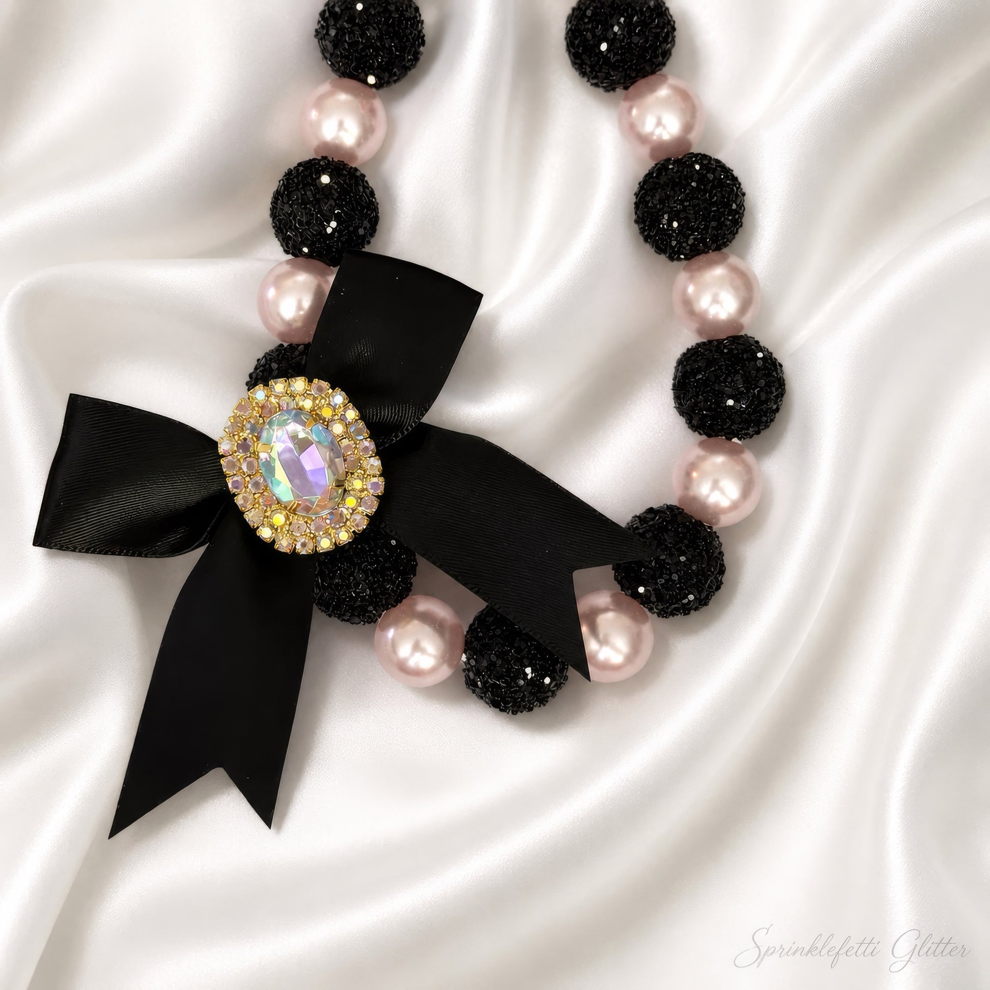 Midnight Blush Heiress Necklace with black beads, blush pearls, and jeweled bow