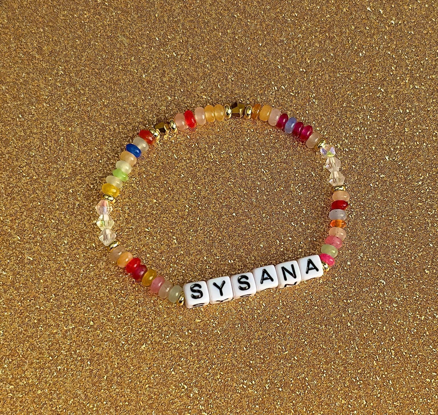 Rainbow Confetti personalized name bracelet on a gold glitter background