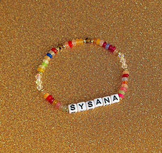Rainbow Confetti personalized name bracelet on a gold glitter background