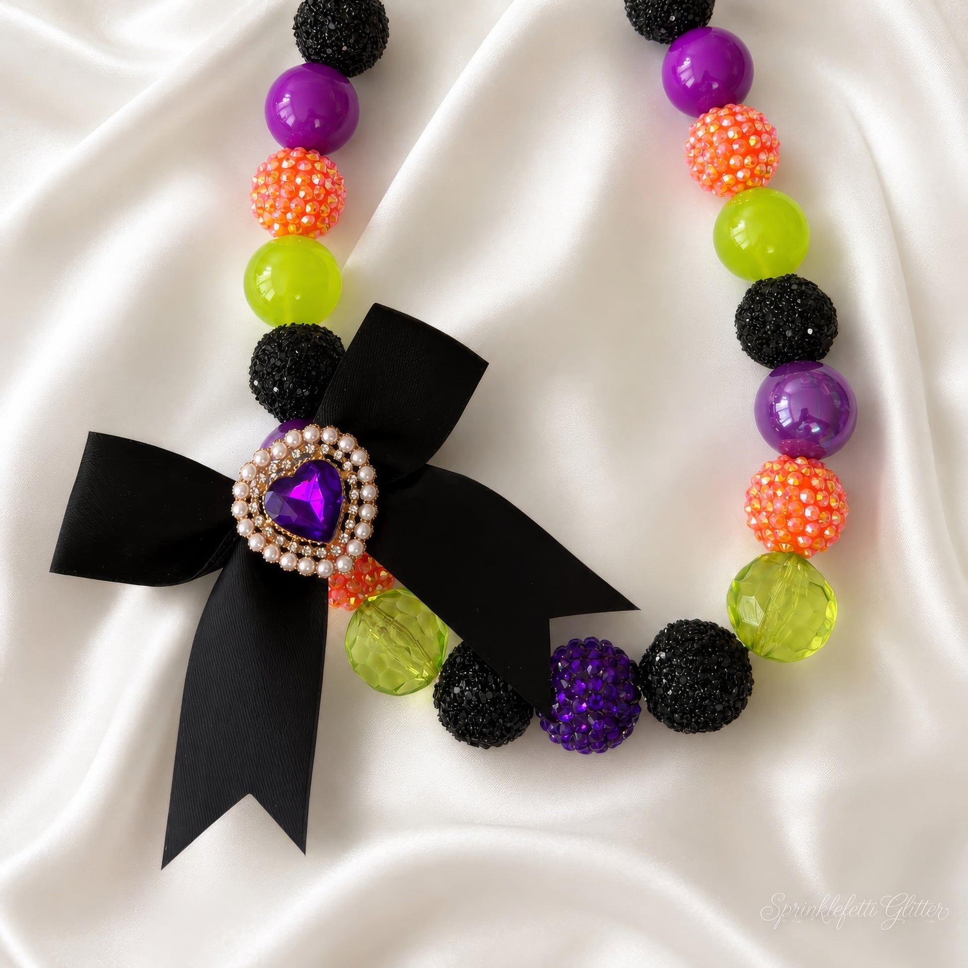 Spellbound Heiress Necklace in purple, orange, lime, and black with heart jewel